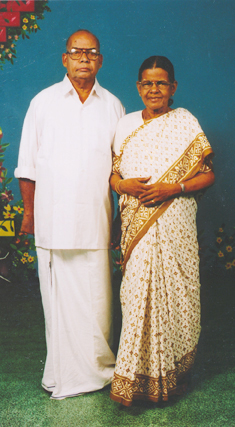 Studio portrait of an elderly gentleman and a lady in a traditional sari